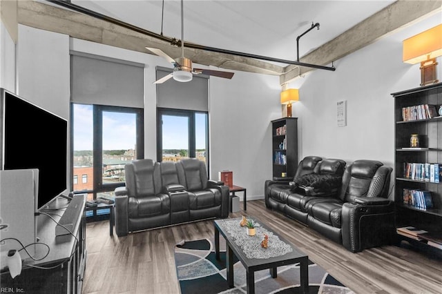 living room featuring wood-type flooring and ceiling fan