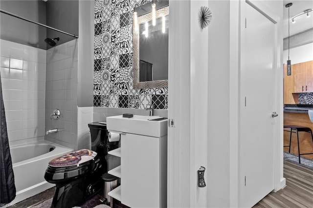 bathroom with toilet, wood-type flooring, backsplash, and shower / tub combo