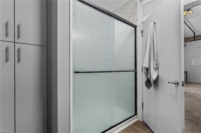 bathroom with a shower with door