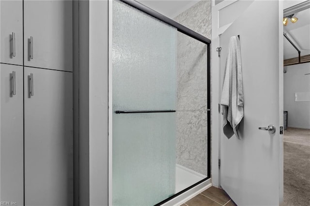 bathroom with tile patterned floors and walk in shower