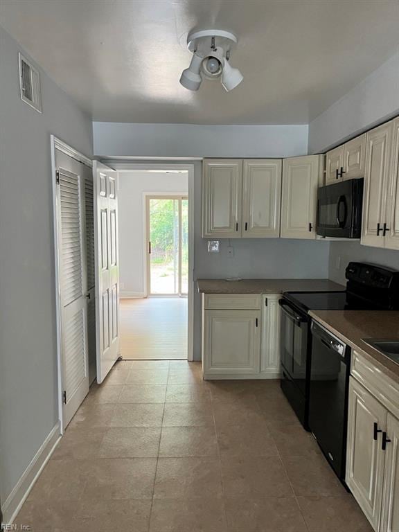 kitchen featuring black appliances, ceiling fan, light tile patterned floors, and cream cabinetry