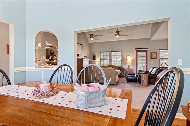 dining room with carpet floors, vaulted ceiling, and ceiling fan