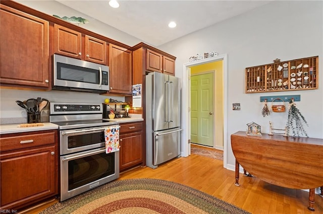 kitchen with light hardwood / wood-style flooring and stainless steel appliances