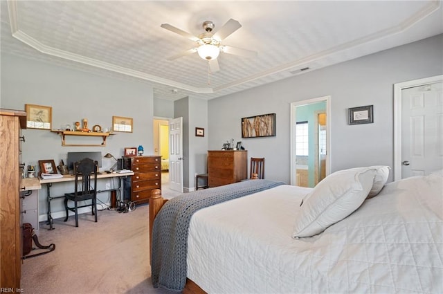 carpeted bedroom with a tray ceiling, ceiling fan, and ornamental molding