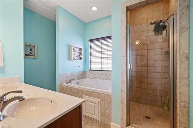 bathroom with tile patterned floors, vanity, and separate shower and tub