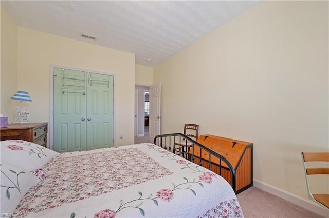 bedroom with light colored carpet and a closet