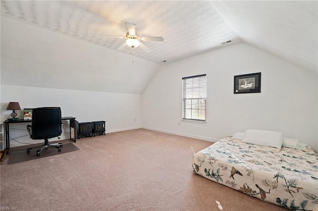 carpeted bedroom with ceiling fan and vaulted ceiling