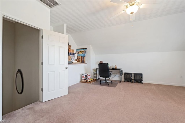 carpeted home office with ceiling fan and vaulted ceiling