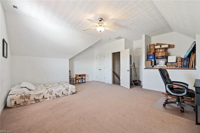 carpeted bedroom with vaulted ceiling and ceiling fan