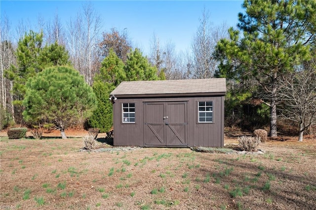 view of outdoor structure featuring a lawn