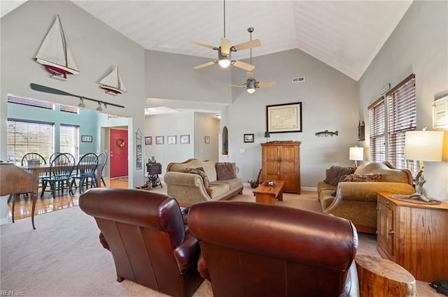 living room featuring ceiling fan, light colored carpet, and high vaulted ceiling