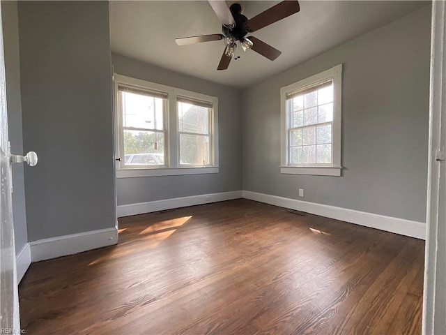 empty room featuring ceiling fan and dark hardwood / wood-style floors