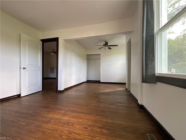 spare room with ceiling fan and dark hardwood / wood-style flooring