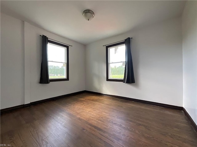 spare room featuring dark hardwood / wood-style flooring