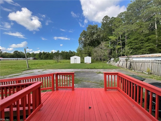 wooden terrace featuring a yard and a shed