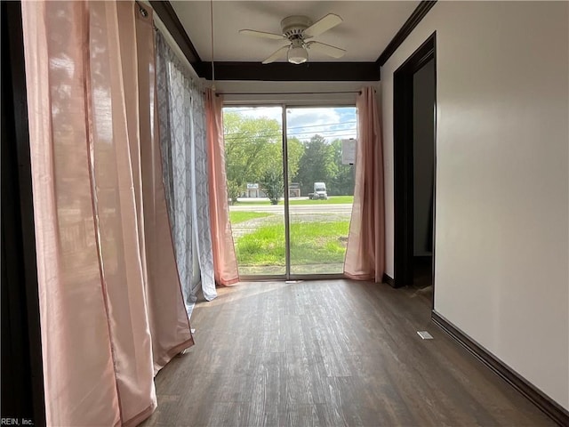 unfurnished room featuring hardwood / wood-style flooring, ceiling fan, and crown molding