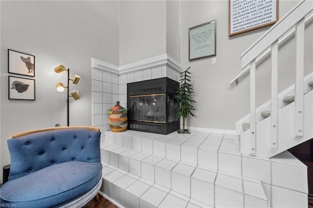 living room with a tile fireplace