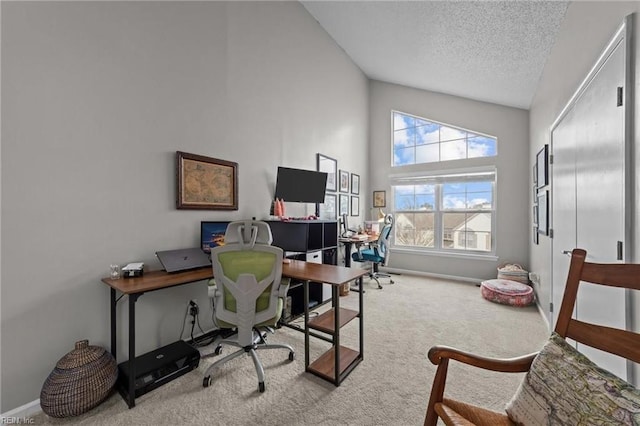 office area with light colored carpet, a textured ceiling, and vaulted ceiling