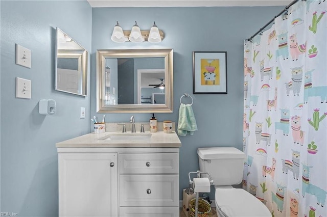 bathroom with vanity, toilet, and curtained shower