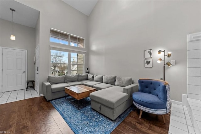 living room with high vaulted ceiling and hardwood / wood-style flooring