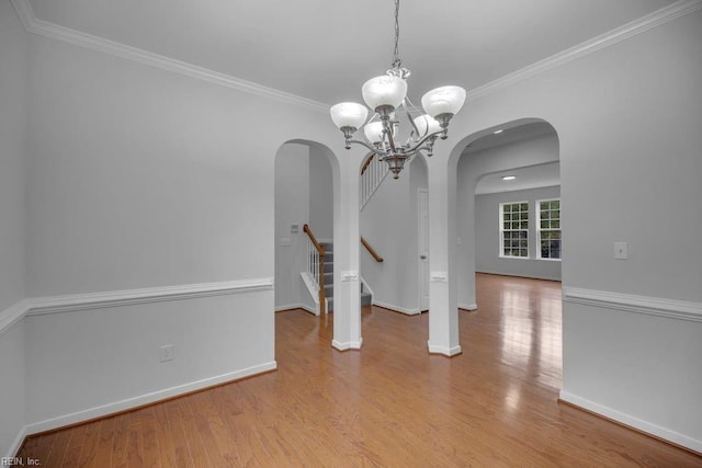 unfurnished dining area with ornamental molding, light hardwood / wood-style flooring, and a notable chandelier