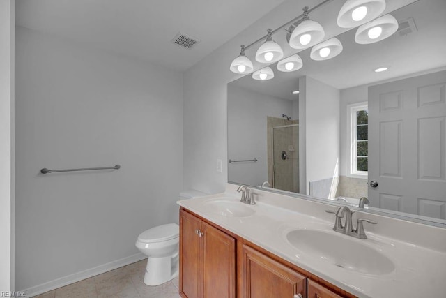 bathroom with tile patterned floors, vanity, toilet, and walk in shower