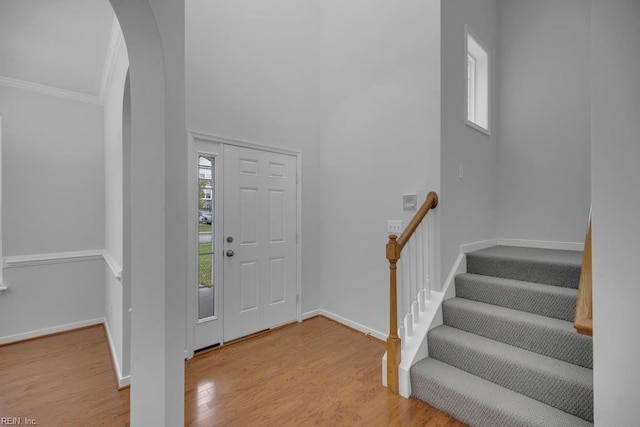 entrance foyer featuring light hardwood / wood-style floors and ornamental molding