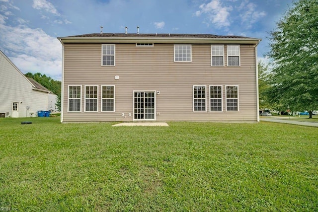 rear view of house featuring a yard