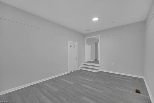 unfurnished room with wood-type flooring