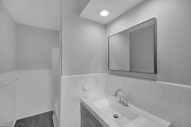 bathroom with vanity, tile walls, and hardwood / wood-style flooring