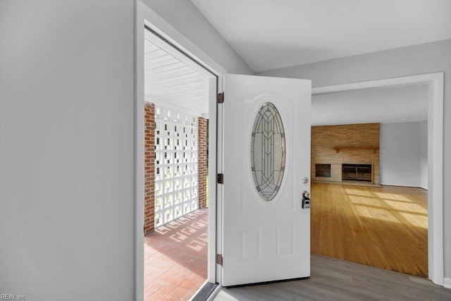 entryway featuring light wood-type flooring and a fireplace