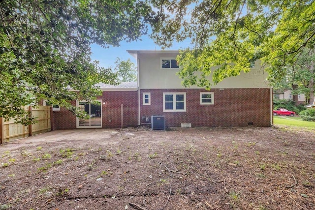 back of house with central AC unit