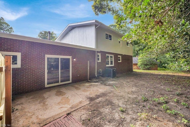 back of house with central AC unit