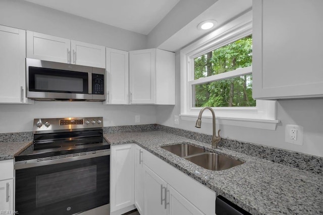 kitchen with sink, white cabinets, and stainless steel appliances