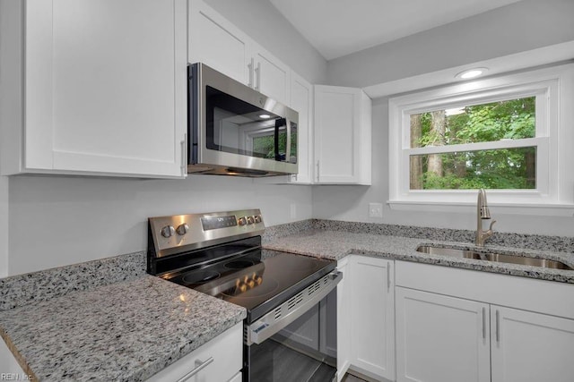 kitchen featuring white cabinets, stainless steel appliances, and sink