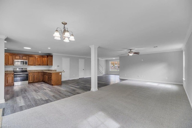 kitchen featuring stainless steel appliances, crown molding, decorative light fixtures, carpet, and ceiling fan with notable chandelier