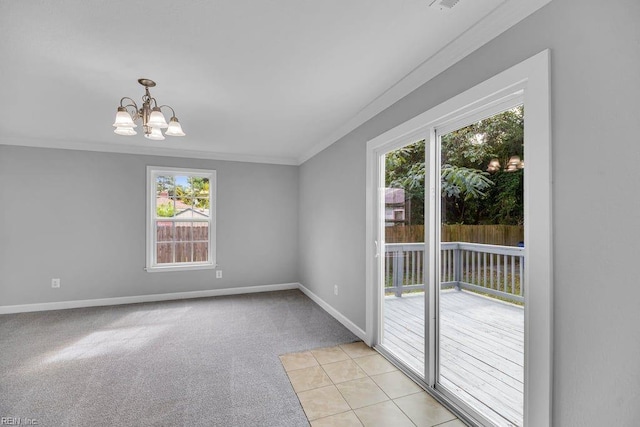 spare room featuring a chandelier, light carpet, and crown molding