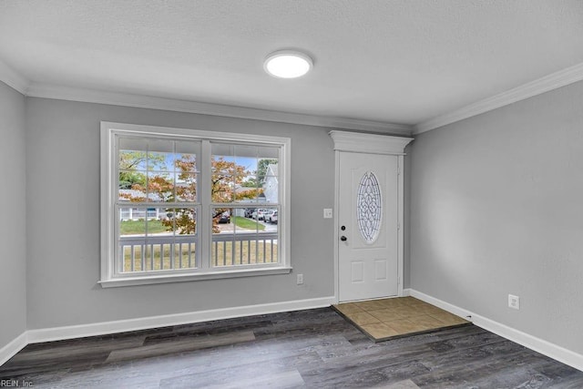 entryway with a textured ceiling, dark hardwood / wood-style floors, and ornamental molding