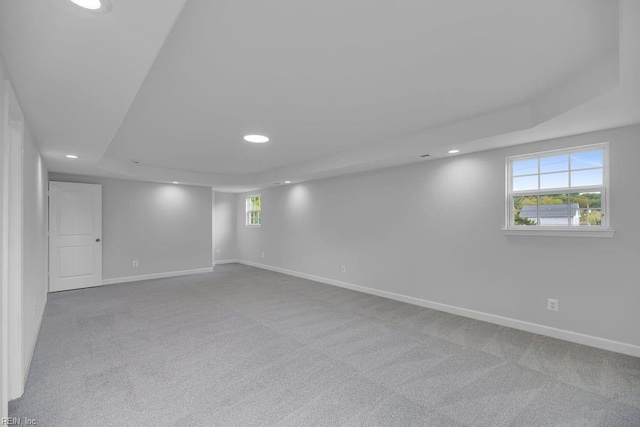 basement featuring light carpet and a wealth of natural light