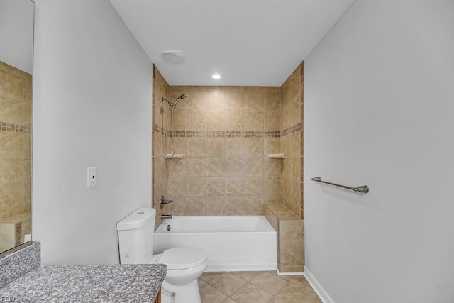 full bathroom with tiled shower / bath, tile patterned flooring, vanity, and toilet