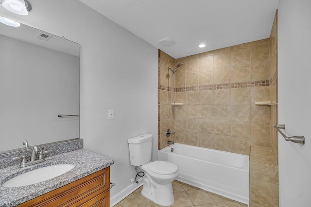 full bathroom with tile patterned floors, vanity, tiled shower / bath combo, and toilet