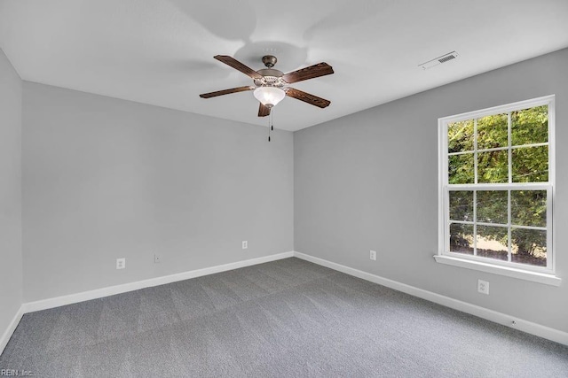 carpeted spare room with ceiling fan