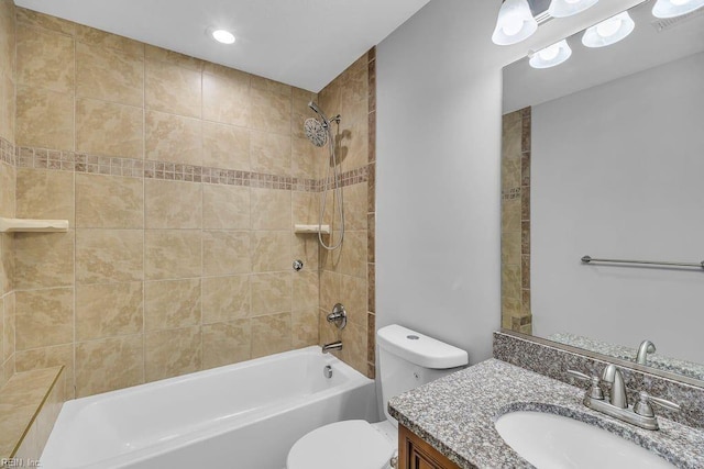 full bathroom featuring vanity, toilet, and tiled shower / bath