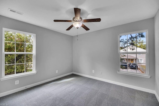 carpeted spare room with ceiling fan