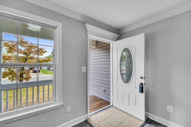 tiled foyer entrance with crown molding