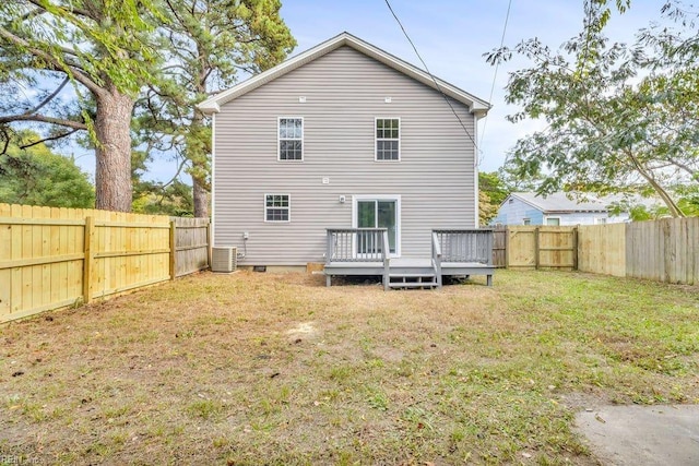 rear view of house featuring a yard, cooling unit, and a deck