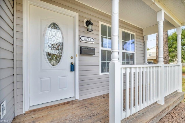 view of exterior entry with a porch