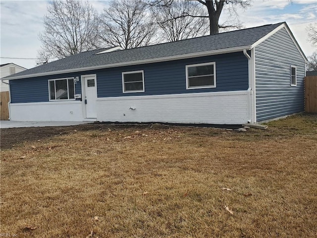 ranch-style home with a front lawn