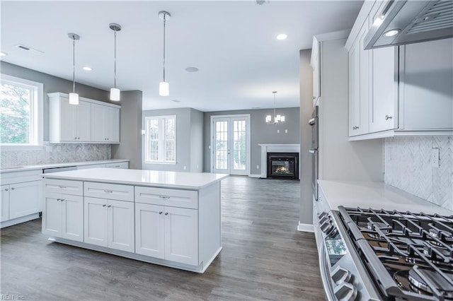 kitchen with white cabinets, custom range hood, a center island, and pendant lighting