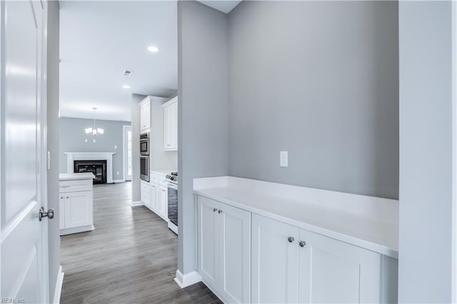 corridor with hardwood / wood-style floors